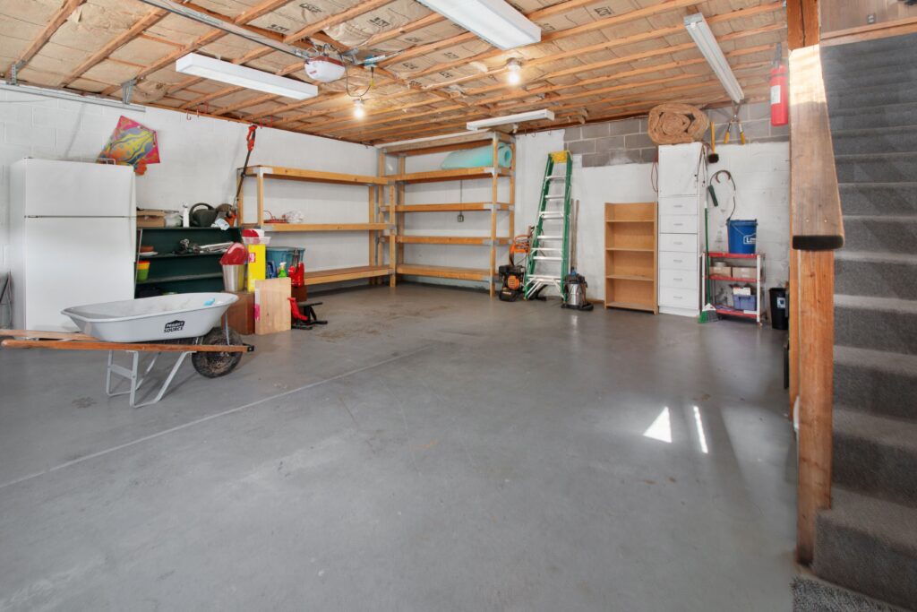 Organized garage interior with ceiling mounted garage door opener