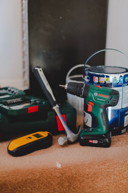 Home improvement tools including drill, hammer and supplies for garage door opener installation