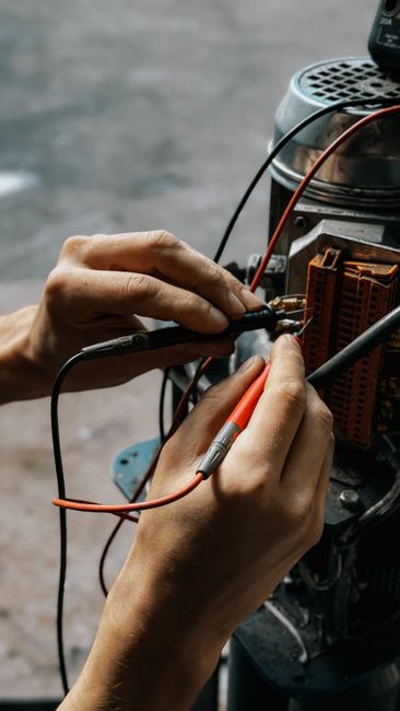 How to Fix LiftMaster Error Code 1-5 (Step by Step) 3 Technician using multimeter to test garage door opener motor wiring