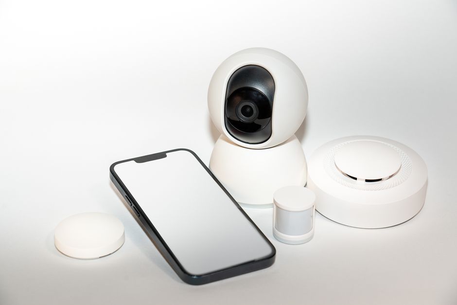 Collection of smart home security gadgets with smartphone for garage door monitoring