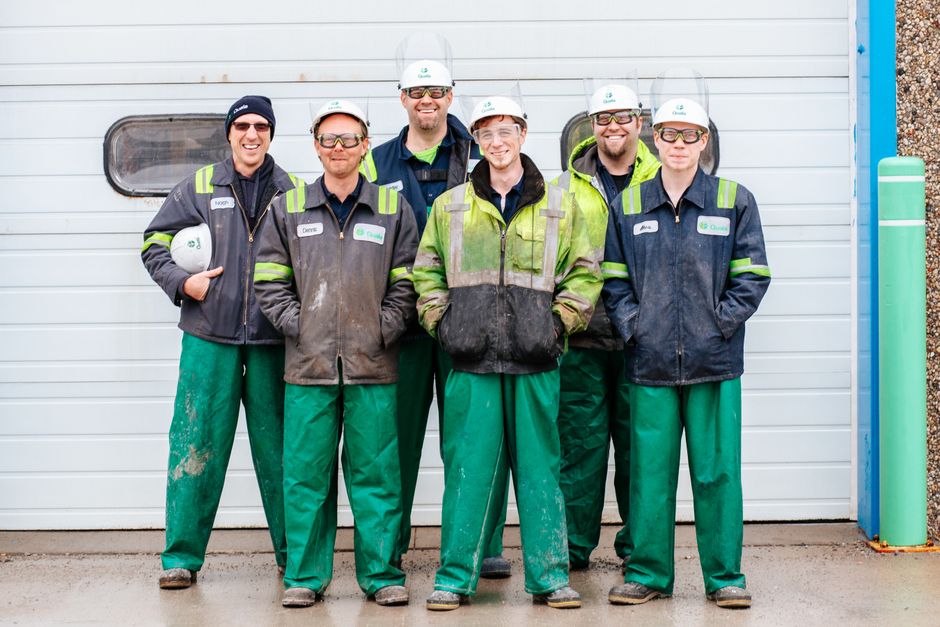 How Much Does a 16x7 Garage Door Weigh? (By Material) 4 Industrial workers in safety gear in front of a garage door for installation reference