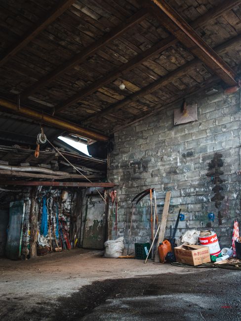 Genie Model 450 Garage Door Opener: Fix or Replace? 3 Old weathered workshop with scattered tools, representing worn garage equipment