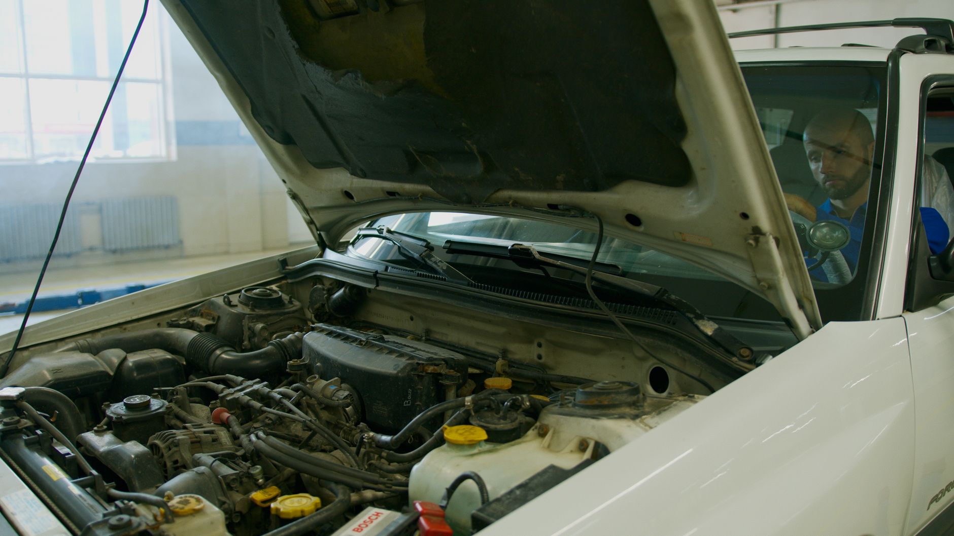 Technician troubleshooting garage door opener