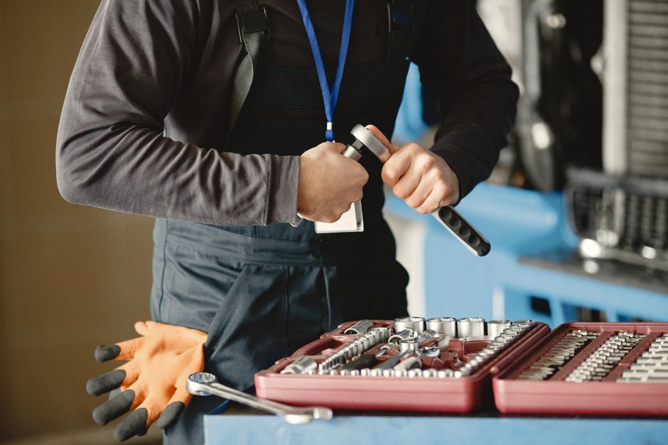 Best Garage Door Opener for Heavy Doors (2026 Picks) 4 Mechanic preparing tools for heavy garage door opener installation