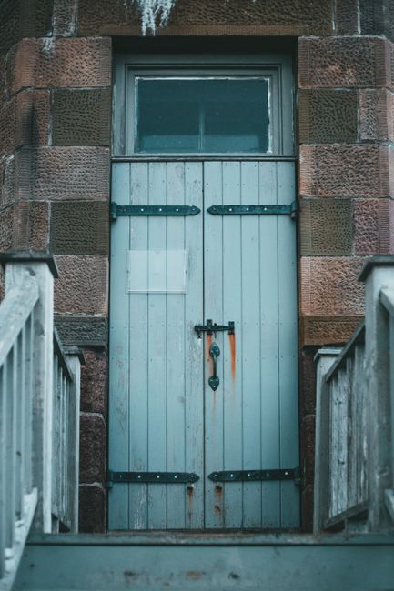 Best Garage Door Opener for Heavy Doors (2026 Picks) 2 Heavy wooden door with iron hinges representing a heavy garage door
