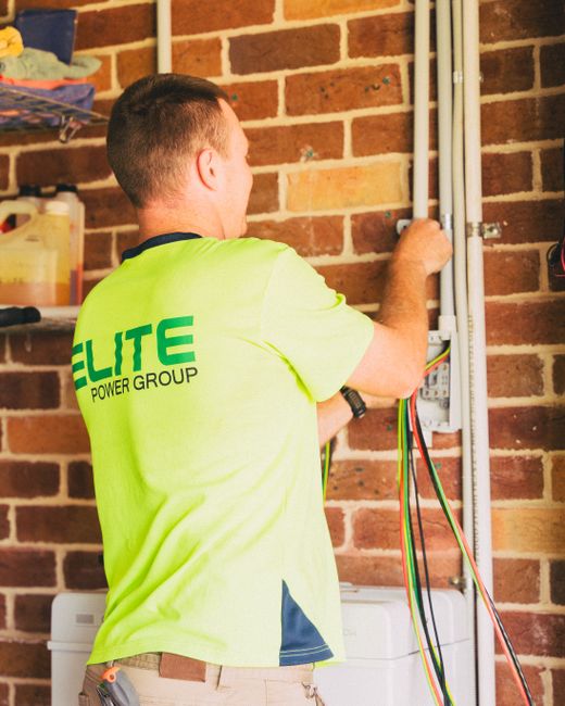 Technician wiring a smart home device to enable Alexa control