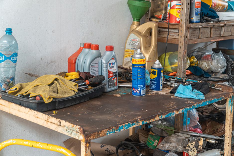 Workbench with oil cans and maintenance lubricant products for garage door care