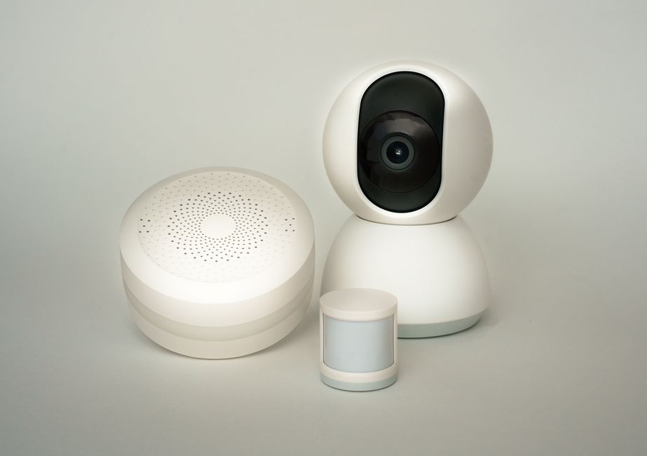 Modern smart home security devices including camera and sensors for garage monitoring