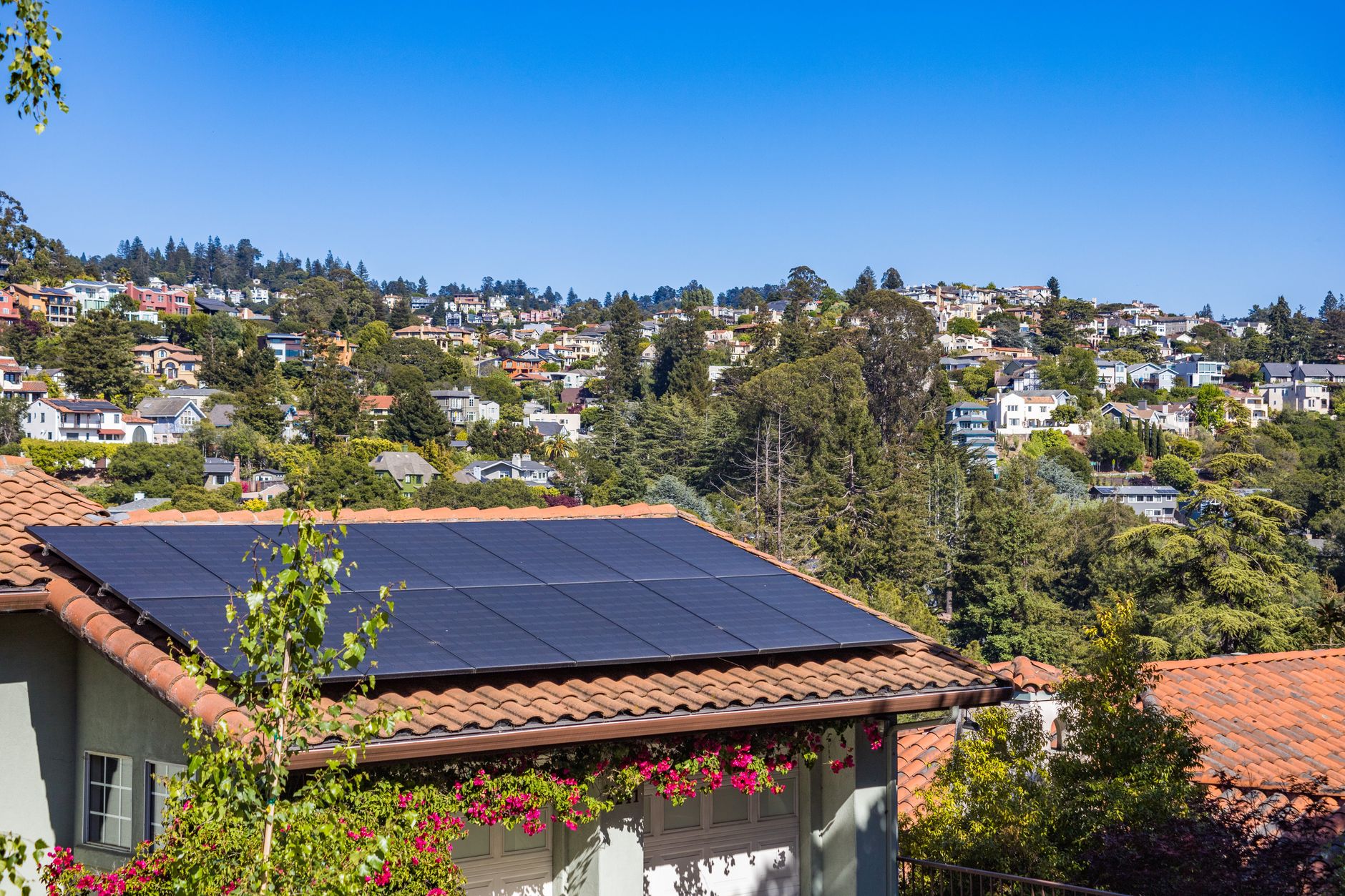 Is a Solar Powered Garage Door Opener Worth It? 2 Solar panels on home roof for garage door power