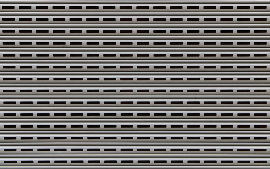 How Much Does a 16x7 Garage Door Weigh? (By Material) 2 Close-up of textured metal roll-up door panels showing steel garage door construction