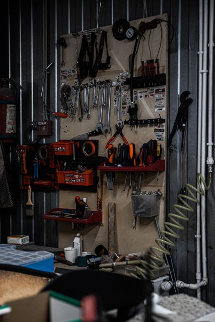 False Wall Behind a Garage Door: Clearance and Framing Guide 2 Well-organized garage workshop with storage, an example of a finished false wall storage area