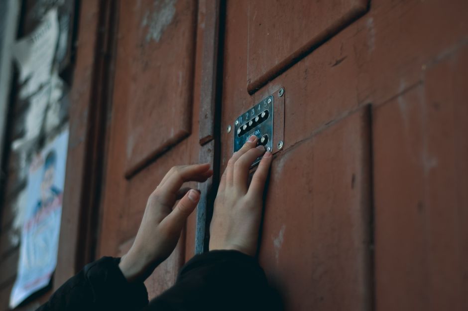 Garage Door Keypad Not Working in Cold Weather: The Fix 4 Hand pressing buttons on a keypad mounted near a door