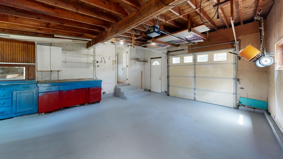 False Wall in Front of a Garage Door: How to Build It Right 2 Empty garage interior before building a false wall in front of the garage door