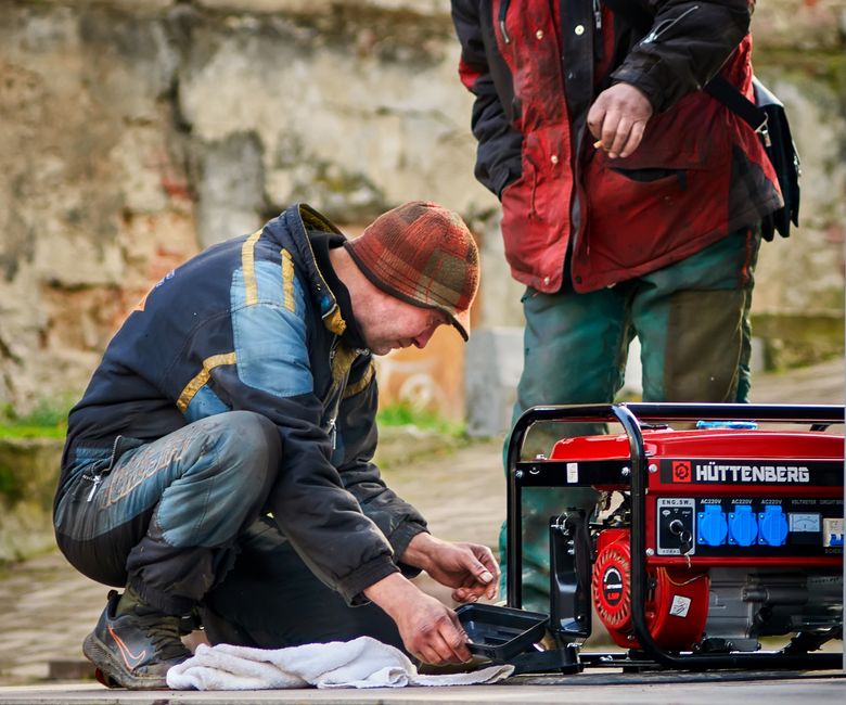 Genie Garage Door Opener Amp Draw: Full Circuit Guide 6 Technicians working on a portable generator outdoors