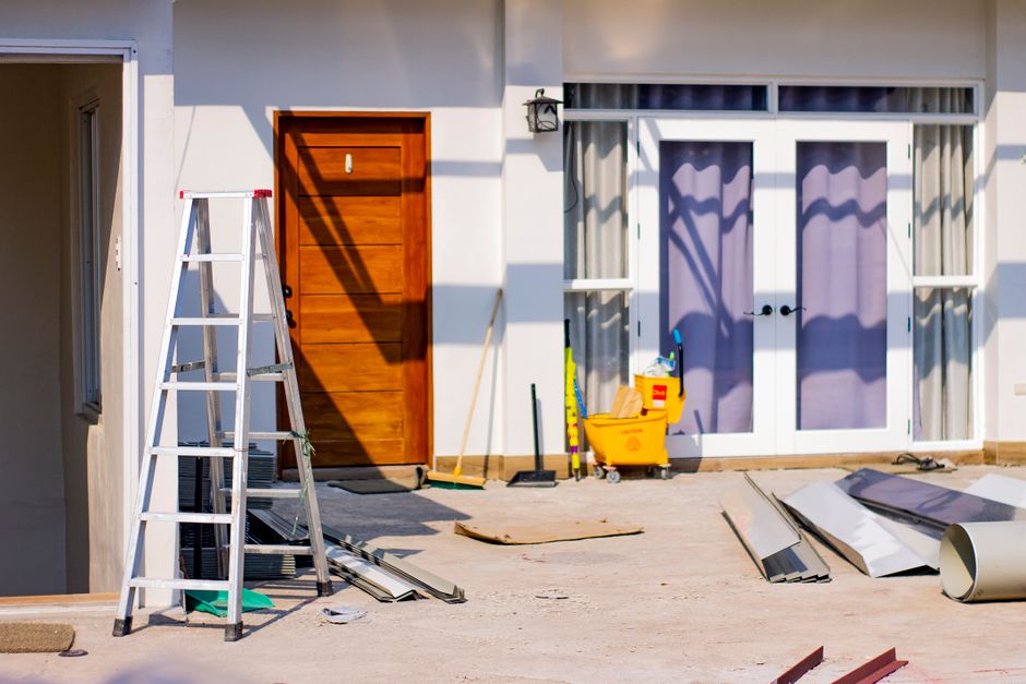 House entrance under renovation with tools and materials, representing a garage conversion project