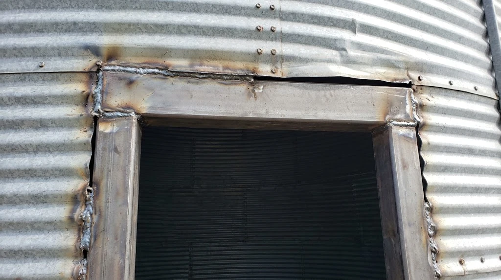 Garage Door in a Grain Bin: What It Takes to Install One 4 Steel header and jambs welded into a grain bin wall opening