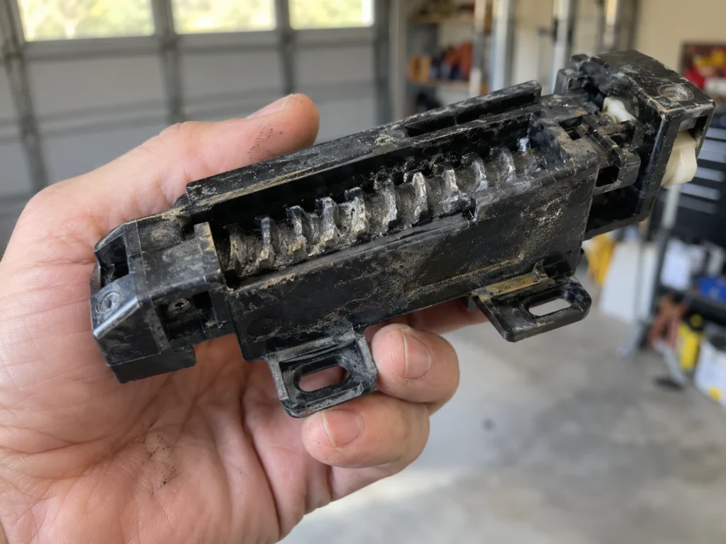 Worn plastic screw-drive opener carriage with teeth worn smooth